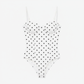 White polka dot corset bodysuit flat lay product shot