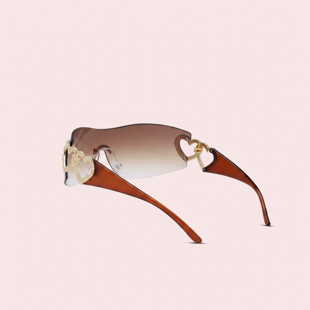Rimless wraparound shield sunglasses with brown gradient lenses and gold double heart embellishment