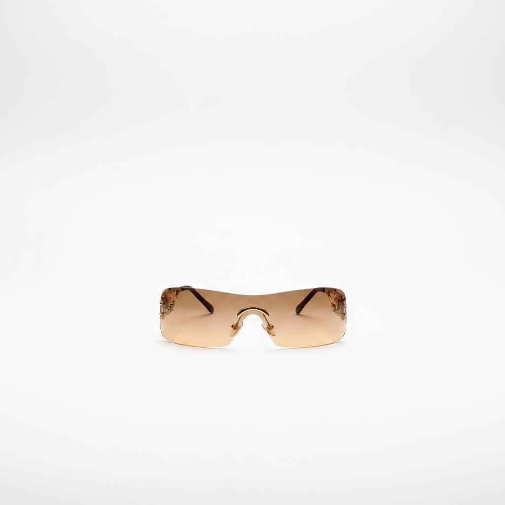 Rimless wraparound shield sunglasses with amber brown gradient lenses and gold ornate temple detail